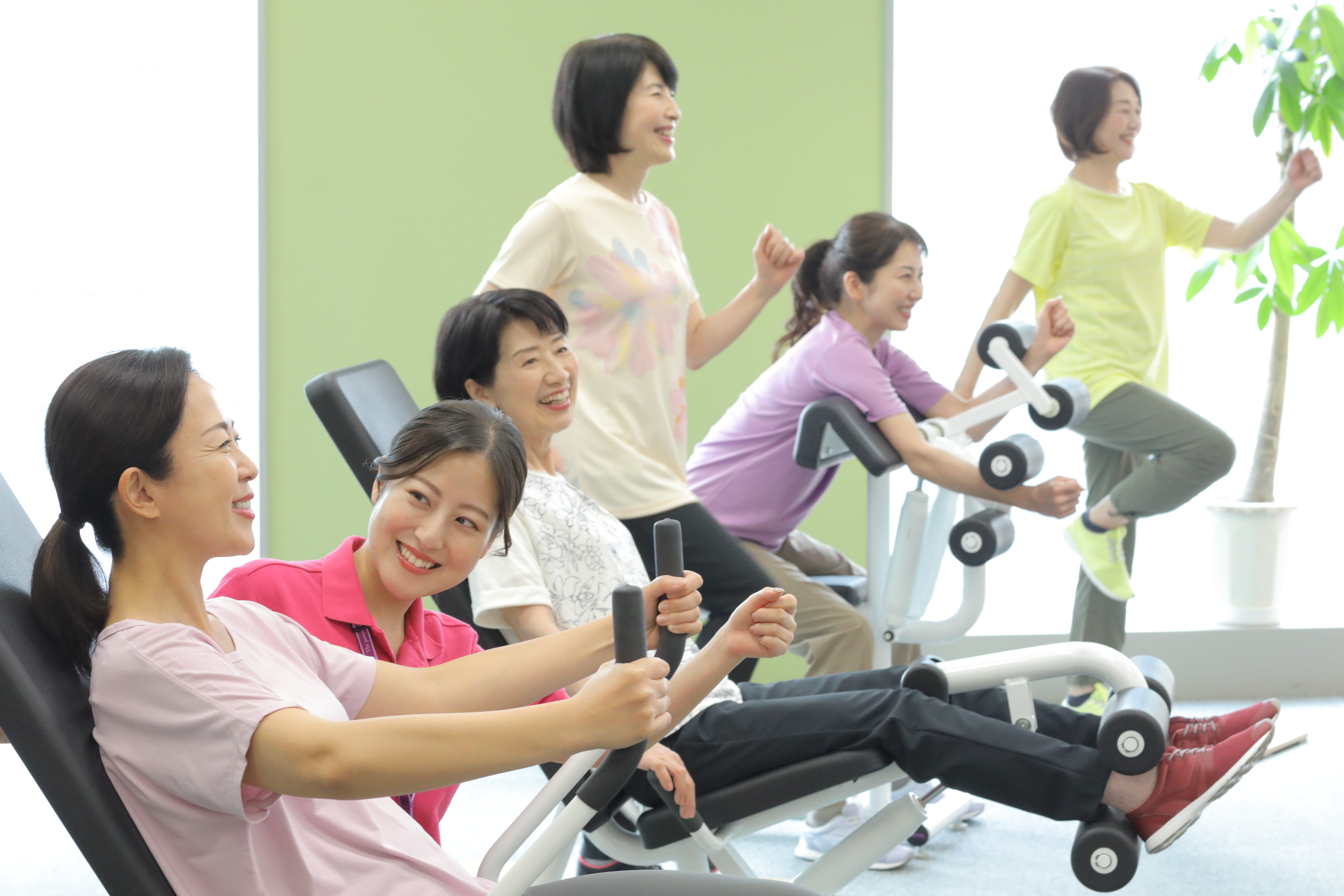 スタッフとお客様が笑顔で運動に取り組む様子